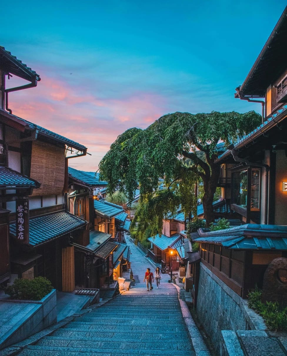 Charming traditional street with wooden houses at sunset.