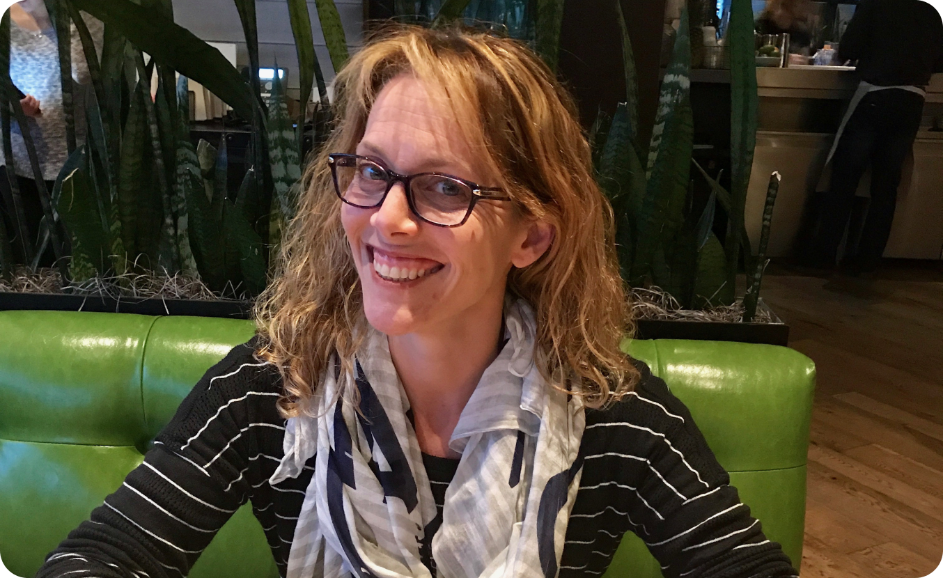 Woman in striped shirt sitting indoors