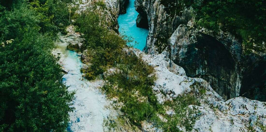 Turquoise river flowing through rocky green canyon