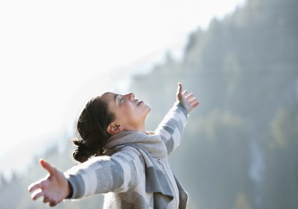 Woman with head back and arms outstretched