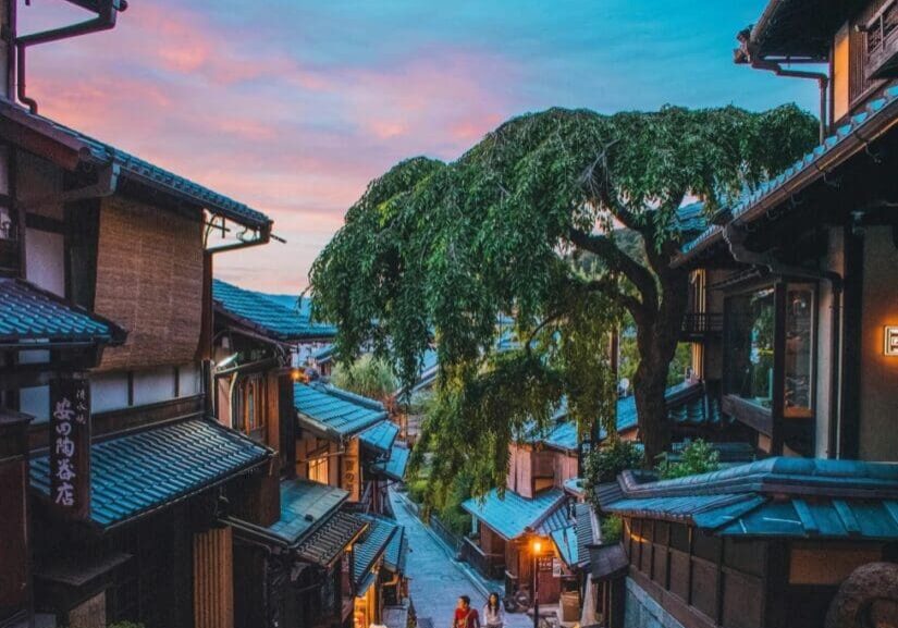 Charming traditional street with wooden houses at sunset.