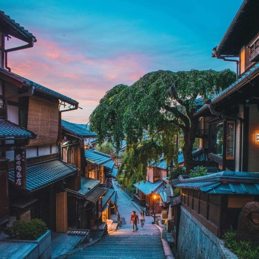 Charming traditional street with wooden houses at sunset.